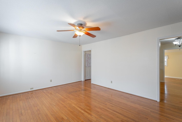 spare room featuring ceiling fan and light hardwood / wood-style flooring