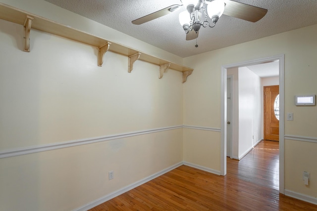 spare room with ceiling fan, a textured ceiling, and hardwood / wood-style flooring