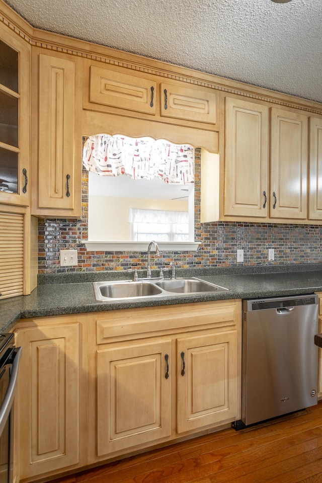 kitchen featuring decorative backsplash, hardwood / wood-style flooring, sink, and appliances with stainless steel finishes