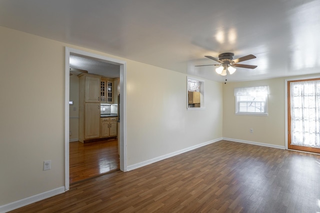 unfurnished room featuring dark hardwood / wood-style floors and ceiling fan