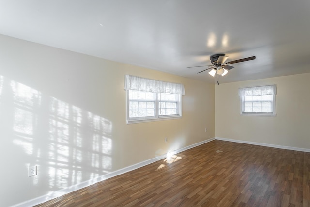 unfurnished room with ceiling fan and dark hardwood / wood-style flooring