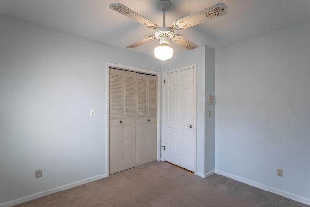 unfurnished bedroom featuring ceiling fan, a closet, and light carpet