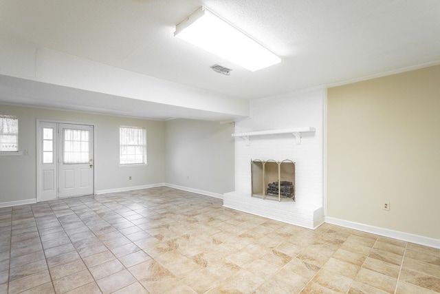 unfurnished living room with a fireplace and light tile patterned flooring