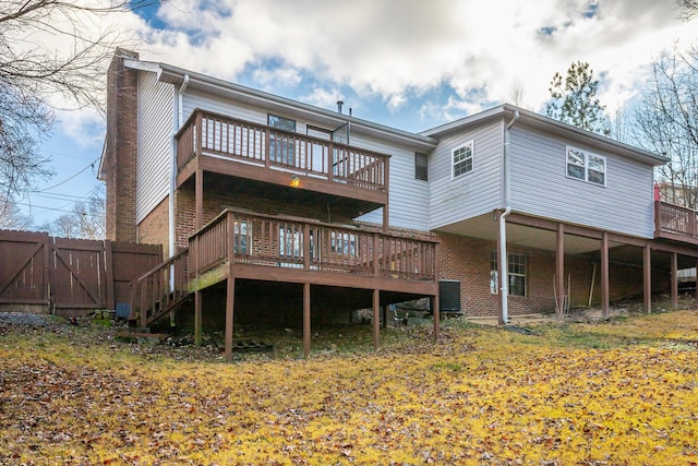 rear view of house featuring central AC and a deck