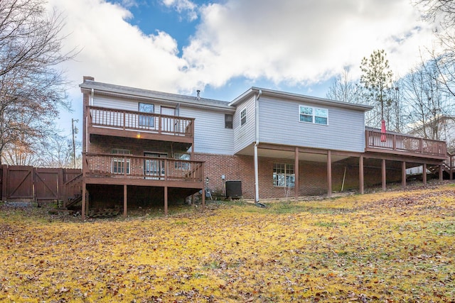 rear view of house featuring central air condition unit and a wooden deck