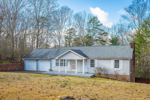 ranch-style home with a front yard, a porch, and a garage