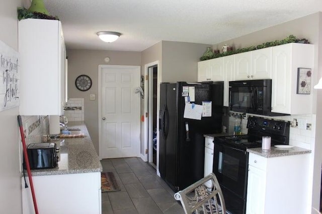 kitchen with sink, tasteful backsplash, a textured ceiling, white cabinets, and black appliances