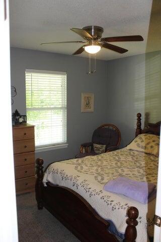 bedroom with multiple windows and ceiling fan