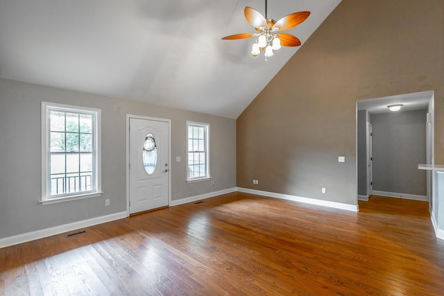 foyer entrance with visible vents, a ceiling fan, high vaulted ceiling, light wood-type flooring, and baseboards