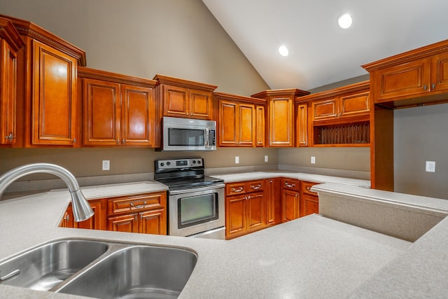 kitchen featuring appliances with stainless steel finishes, light countertops, a sink, and recessed lighting