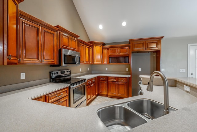 kitchen with a sink, stainless steel appliances, light countertops, and recessed lighting