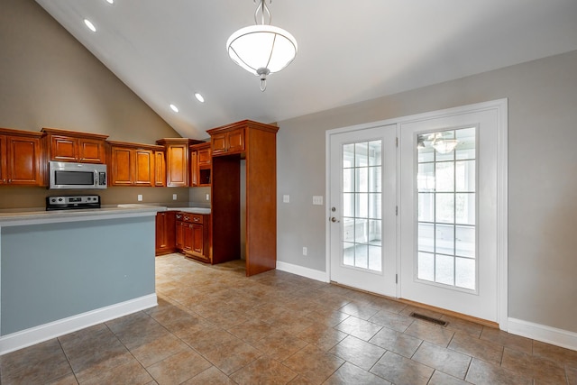 kitchen featuring decorative light fixtures, light countertops, visible vents, appliances with stainless steel finishes, and brown cabinetry