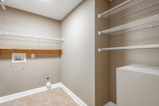 washroom with washer hookup, hookup for an electric dryer, laundry area, baseboards, and tile patterned floors