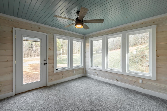 unfurnished sunroom featuring wood ceiling and ceiling fan