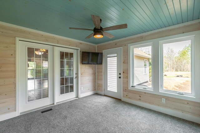 unfurnished sunroom featuring wood ceiling, visible vents, and ceiling fan