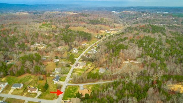 drone / aerial view featuring a view of trees