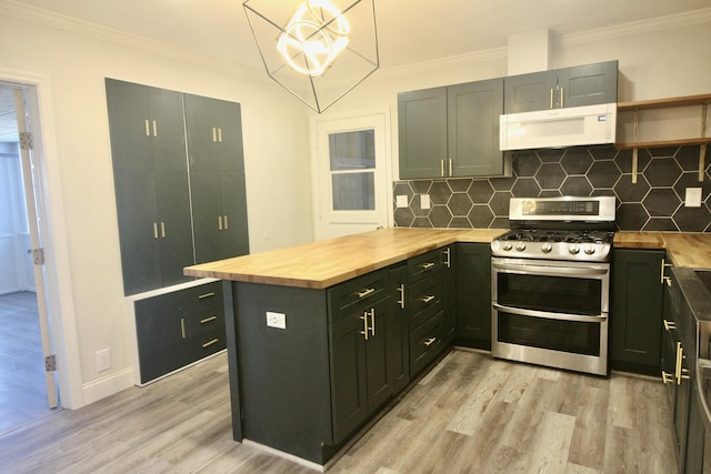 kitchen with wood counters, light wood-type flooring, backsplash, decorative light fixtures, and range with two ovens