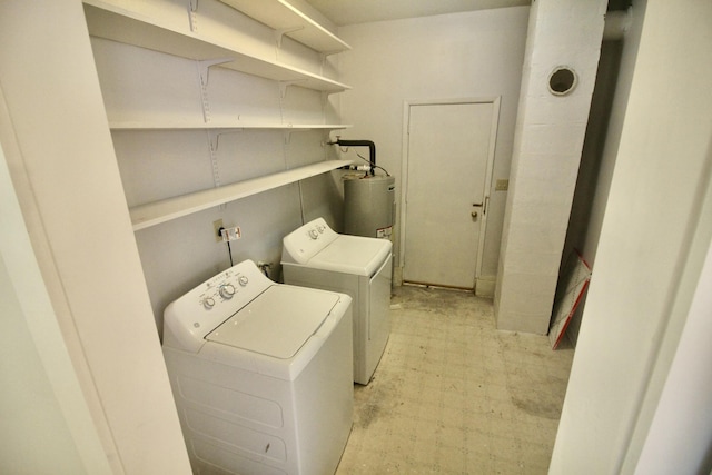 clothes washing area featuring independent washer and dryer and electric water heater