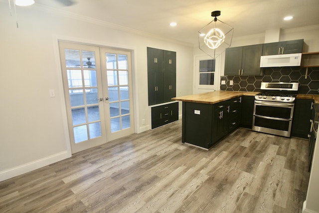 kitchen featuring double oven range, french doors, hanging light fixtures, butcher block countertops, and light hardwood / wood-style floors