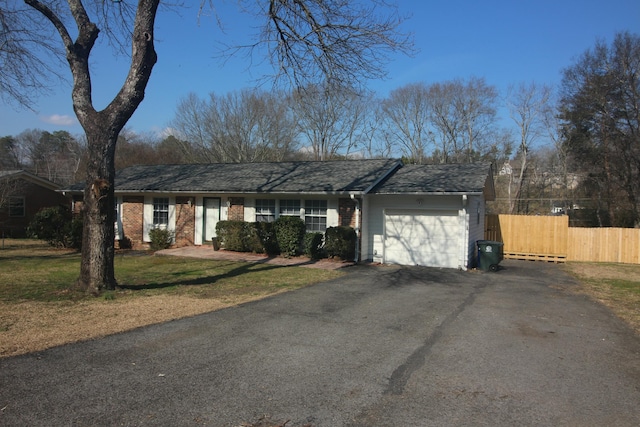 ranch-style home featuring a garage and a front yard