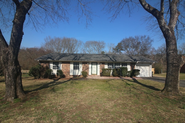 ranch-style home featuring a garage and a front lawn