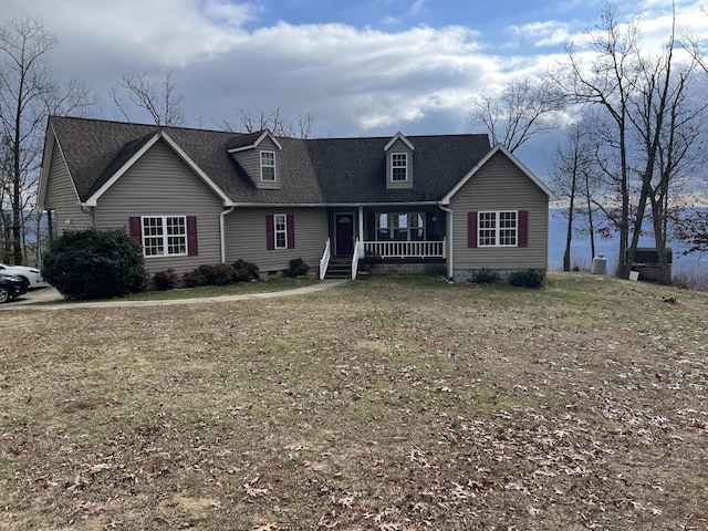 new england style home featuring covered porch and a front yard