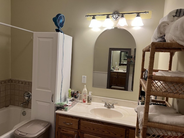 bathroom featuring a bathing tub, vanity, and toilet