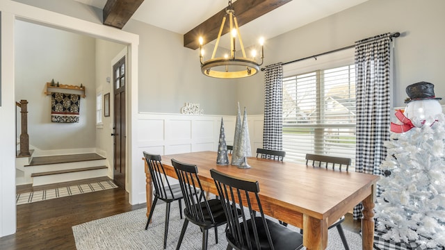 dining area with beam ceiling, dark hardwood / wood-style floors, and an inviting chandelier