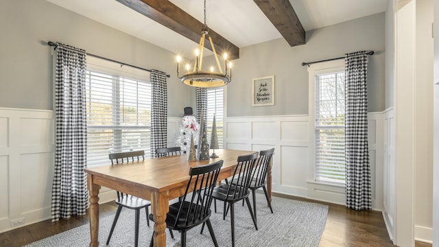 dining room with beamed ceiling, dark hardwood / wood-style flooring, and a chandelier