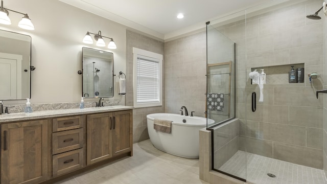 bathroom with tile patterned floors, vanity, tile walls, and plus walk in shower