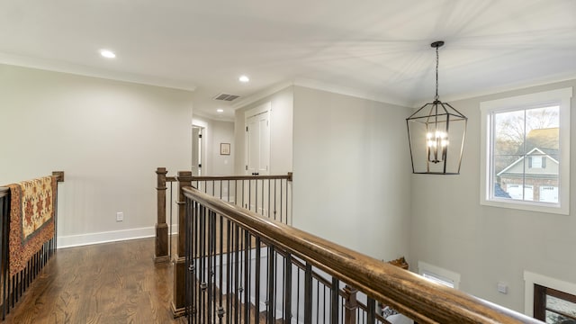 hallway with a chandelier, dark hardwood / wood-style flooring, and crown molding