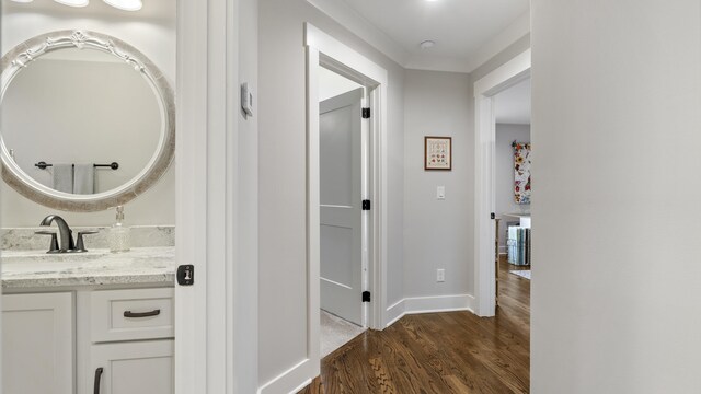 hallway featuring dark hardwood / wood-style flooring and sink