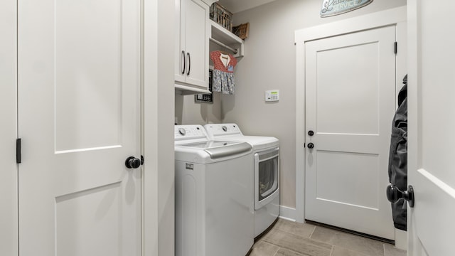 laundry room with cabinets and separate washer and dryer