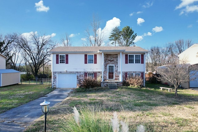 raised ranch with a garage and a front lawn