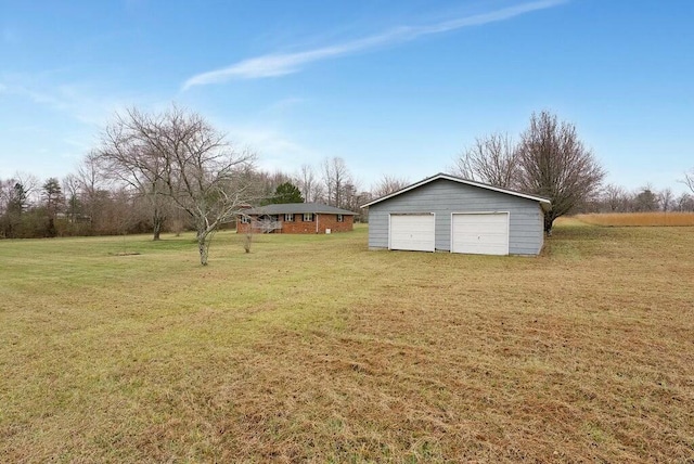 view of yard with an outbuilding and a garage