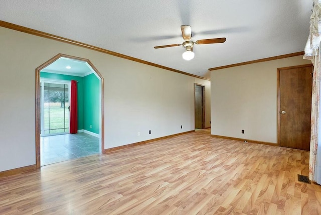 empty room with a textured ceiling, light hardwood / wood-style floors, ceiling fan, and crown molding