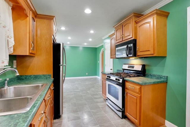 kitchen featuring stainless steel fridge, sink, crown molding, and range with gas stovetop