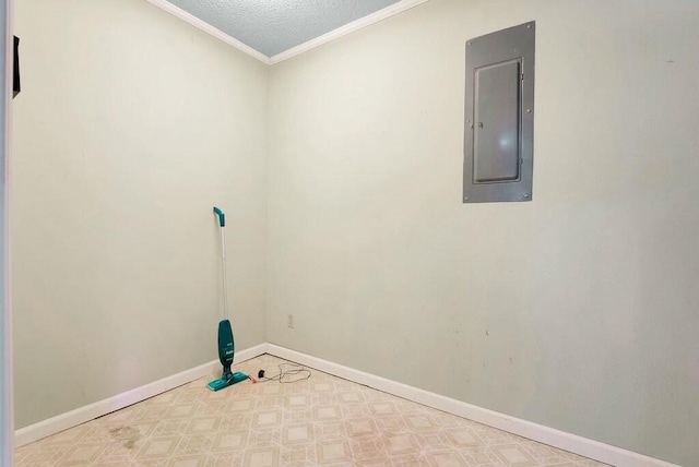 laundry area with ornamental molding, a textured ceiling, and electric panel