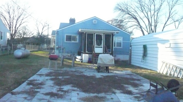 back of property featuring a yard and a patio