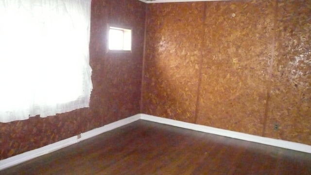 unfurnished room with dark hardwood / wood-style floors