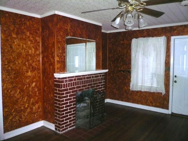 unfurnished living room with a fireplace, wood-type flooring, ceiling fan, and crown molding