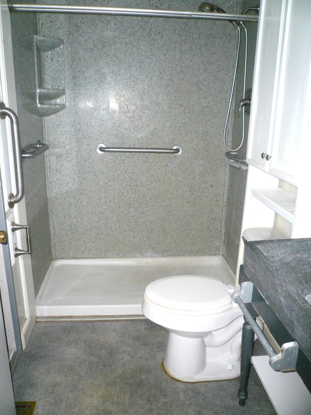 bathroom featuring a shower, vanity, and toilet