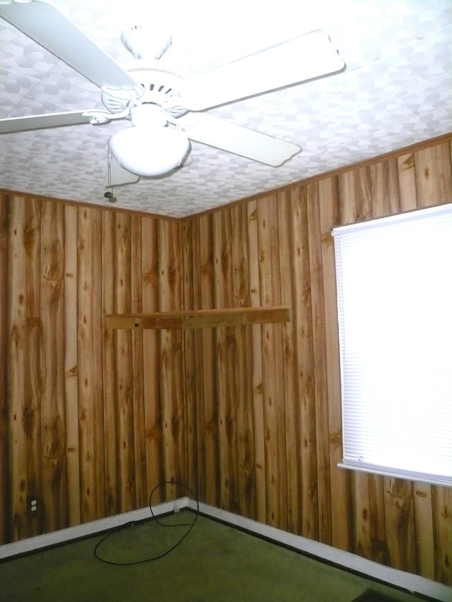 empty room featuring wood walls and a textured ceiling