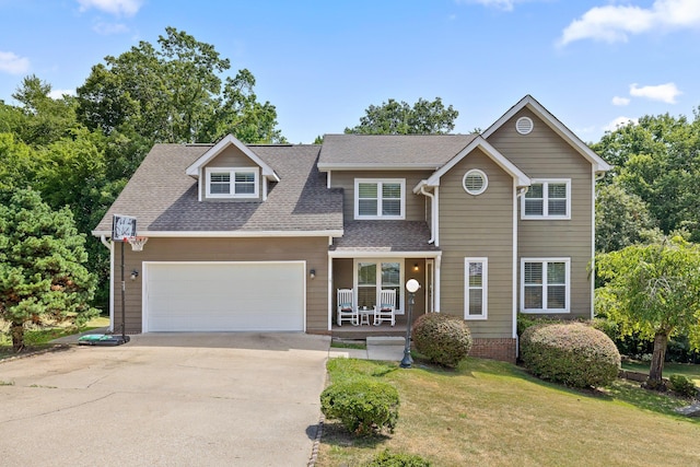 view of front facade featuring a garage, covered porch, and a front yard