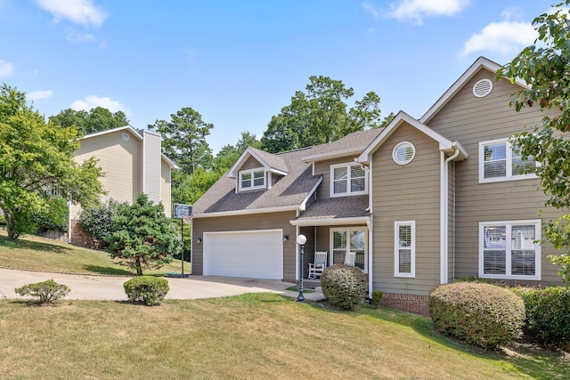 view of front of home with a front yard and a garage