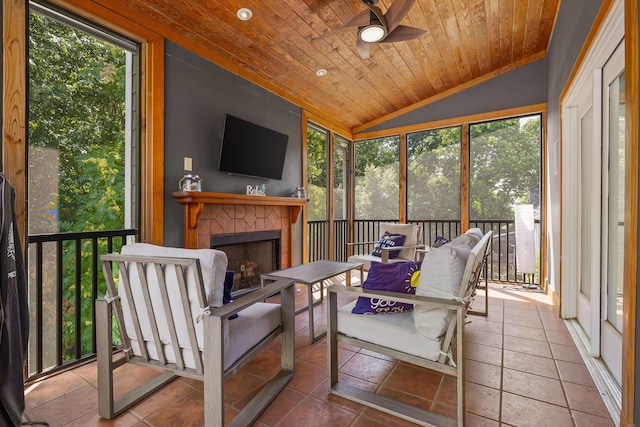 sunroom featuring ceiling fan, plenty of natural light, lofted ceiling, and wood ceiling