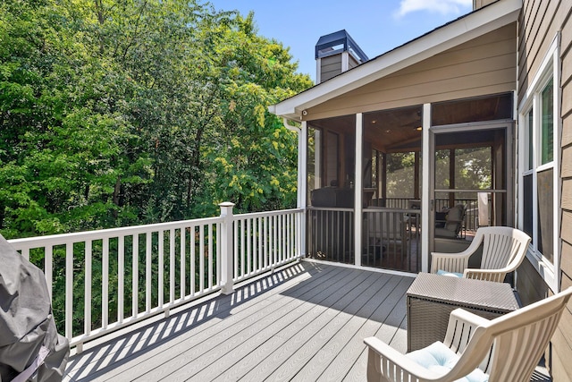 wooden deck featuring a sunroom