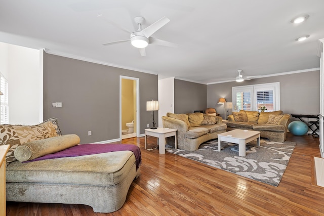 living room with ceiling fan, ornamental molding, and hardwood / wood-style flooring