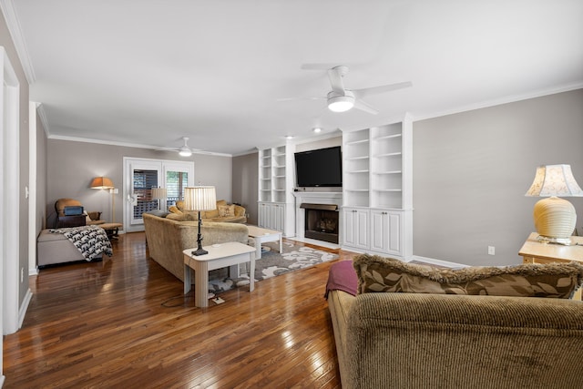 living room with crown molding, ceiling fan, and dark wood-type flooring