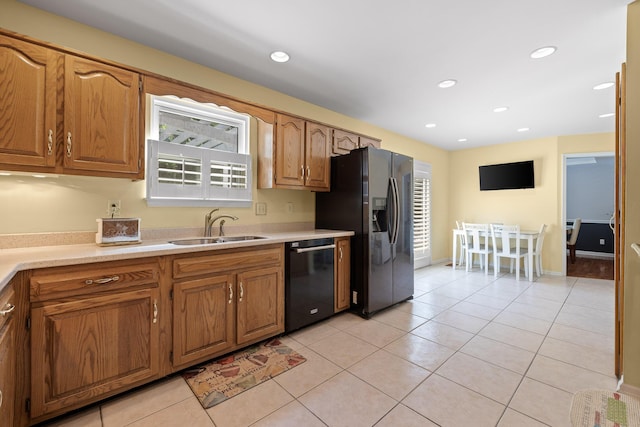 kitchen with dishwasher, light tile patterned floors, refrigerator with ice dispenser, and sink